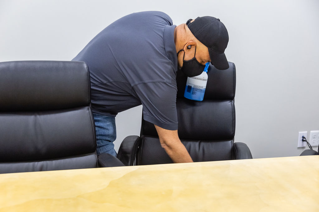 Man cleaning the Chair in the office