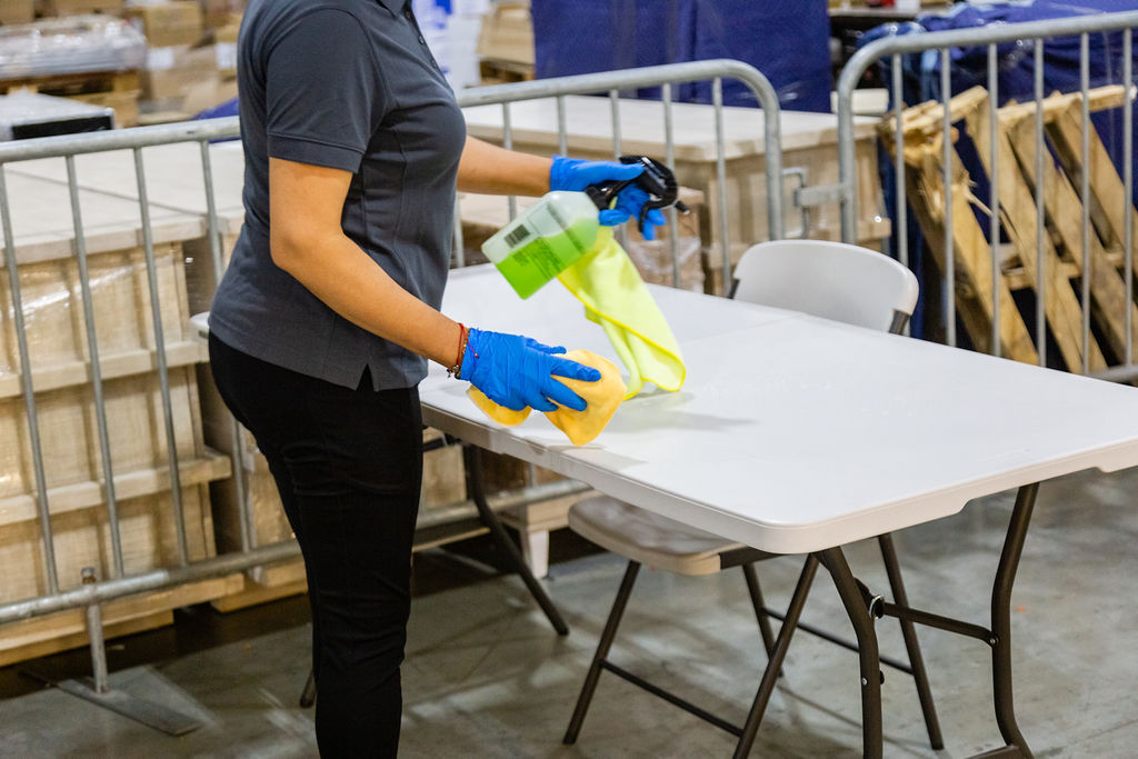 Woman cleaning the table with cleaning spray