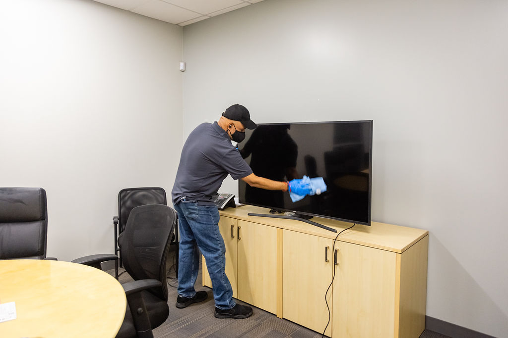 Man cleaning the Television