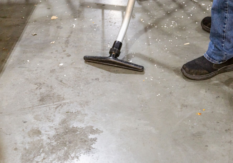 Man cleaning the floor with vacuum cleaner
